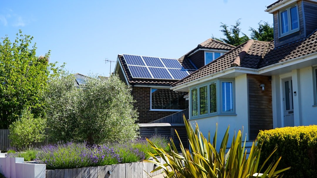 Solar panels in the midday sun on a house roof
