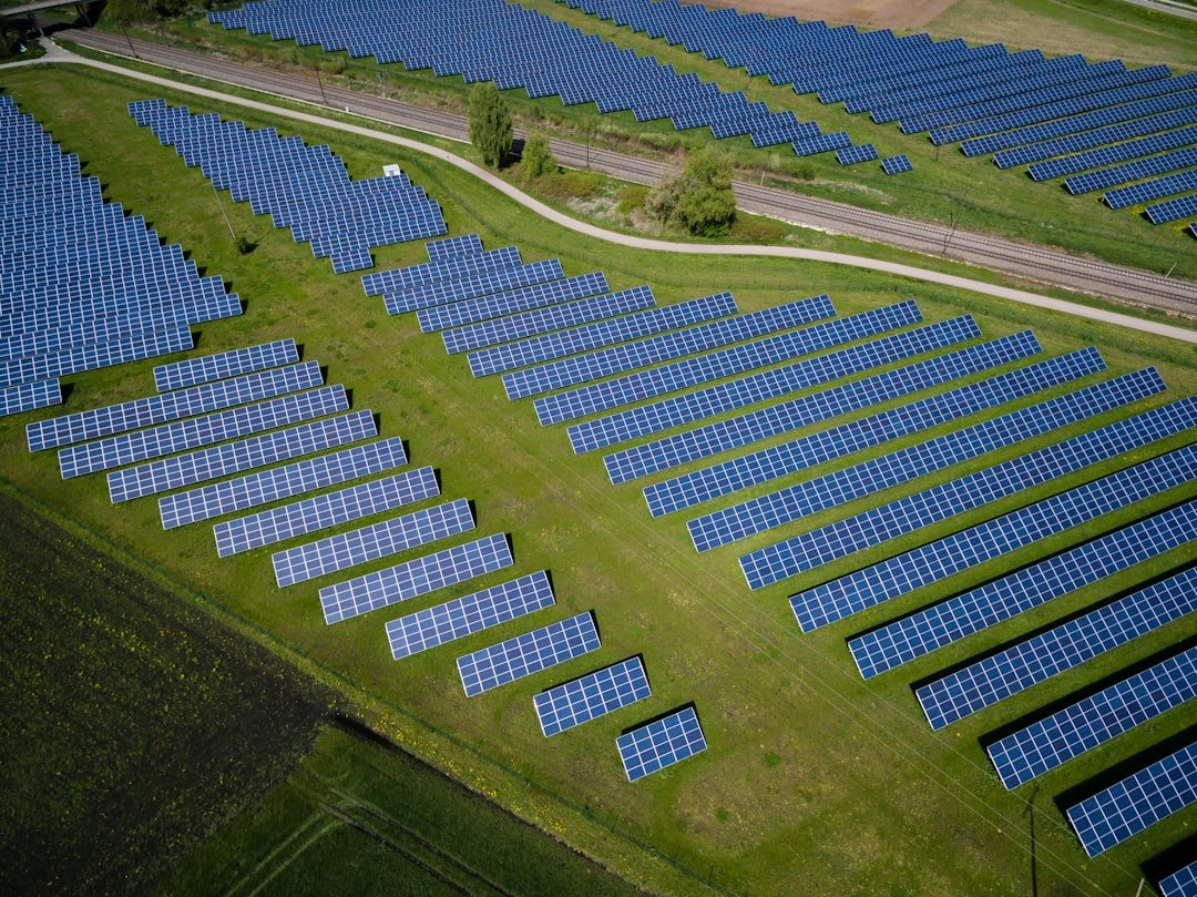 aerial-photography-of-grass-field-with-blue-solar-panels-ilpf2euppue